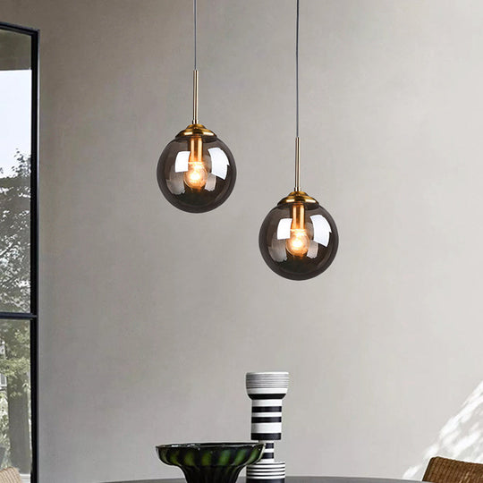 Brass Pendant Lamp With Spherical Amber/Smoke Glass Shade For Dining Room Ceiling