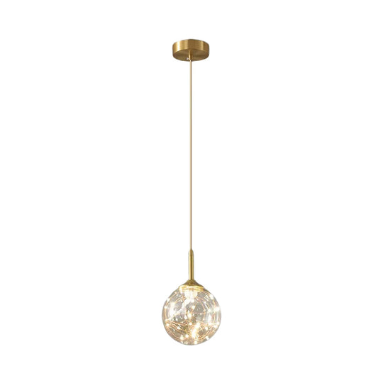 Sleek Brass Sphere Led Pendant Lamp For Modern Dining Rooms