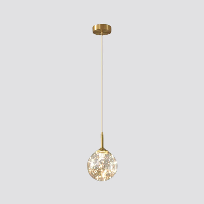 Sleek Brass Sphere Led Pendant Lamp For Modern Dining Rooms