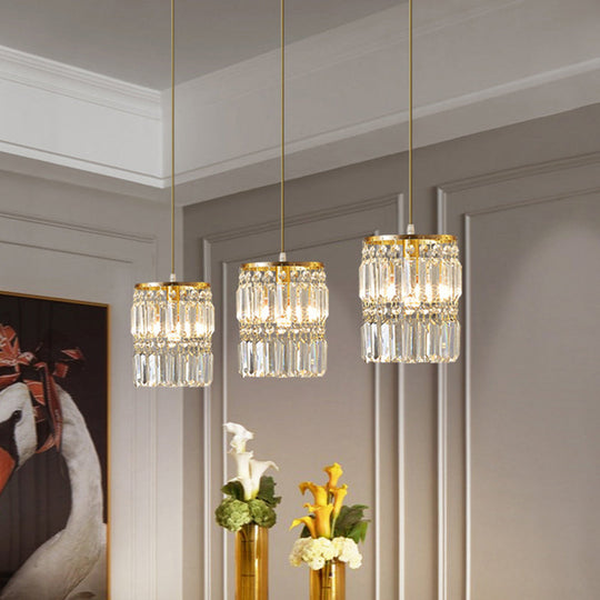 Lustre multi-lumières en laiton avec suspension cylindrique et cristal à trois prismes pour salle à manger contemporaine