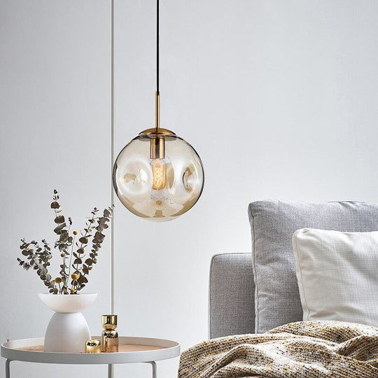 Postmodern Brass Pendant Lamp with Dimpled Glass Globe for Bedroom