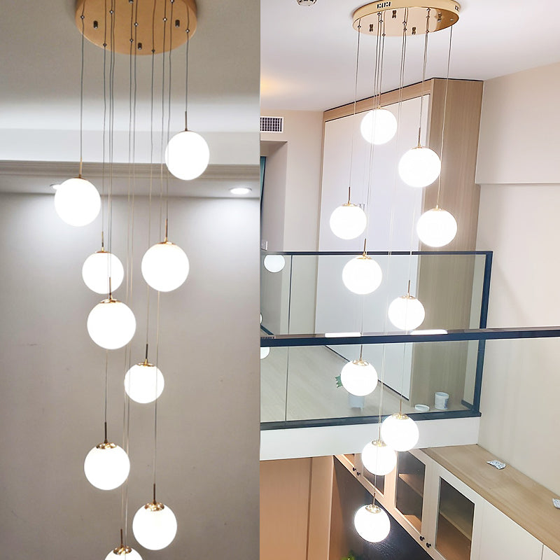 Minimalist Gold Multi-Pendant Ceiling Light with Cream Glass Bubbles and White Glass Staircase Suspension