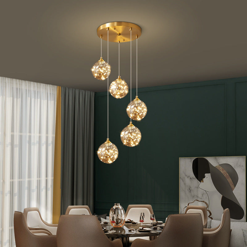 Nordic Amber Glass LED Pendant Lamp with Brass Finish and Starry Design for Bedroom