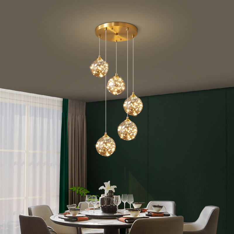 Nordic Amber Glass LED Pendant Lamp with Brass Finish and Starry Design for Bedroom