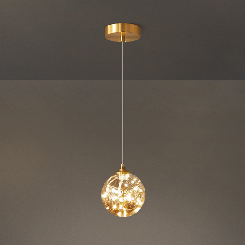 Nordic Amber Glass LED Pendant Lamp with Brass Finish and Starry Design for Bedroom