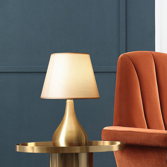 Sleek Metallic Urn-Shape Table Light - Simplicity 1-Light Brass Finish Lamp With Barrel Fabric Shade