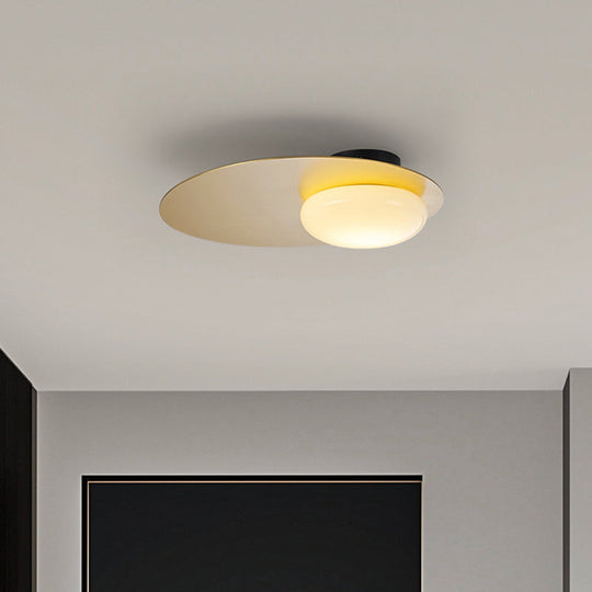 Modern Cream Glass Flush Mount Lamp: Designer 1-Light Ceiling Fixture with Black/Brass Disk Top