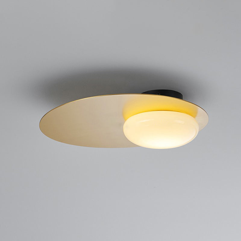 Modern Cream Glass Flush Mount Lamp: Designer 1-Light Ceiling Fixture with Black/Brass Disk Top