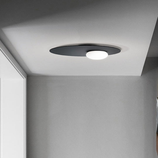 Modern Cream Glass Flush Mount Lamp: Designer 1-Light Ceiling Fixture with Black/Brass Disk Top